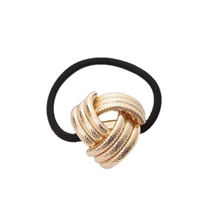 Minimalist gold metal knot hair tie with black elastic band on white background