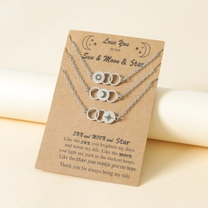 Detailed view of interconnected sun, moon, and star rings on a gift display card