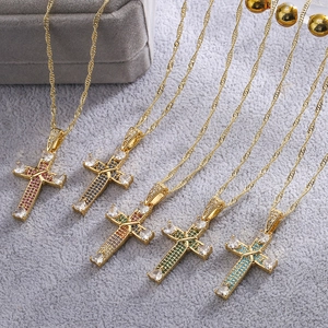 Five 18K gold-plated cross pendant necklaces with multicolored zircon on gray velvet