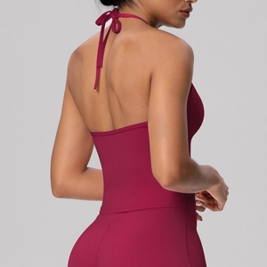 Detail view of the open back and halter tie design on dark red elastic sports bra