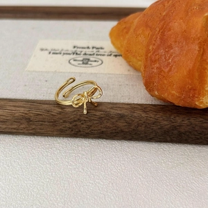 Minimalist S925 sterling silver bow ring with vintage gold finish and adjustable open band
