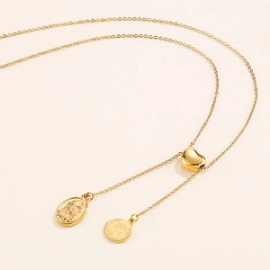 Golden stainless steel lariat necklace featuring heart slider and queen coin pendants