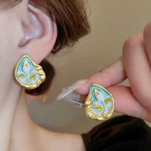 Detail of French vintage tulip earrings with gold plating, enamel, and small pearl