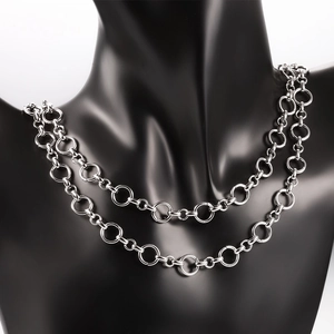 Double layered silver stainless steel chain necklace with circular links on a black bust
