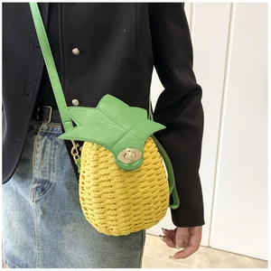 Detail of pineapple woven crossbody bag with green leaf flap and gold rotary lock