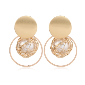 Detail of gold matte earrings with white beads and open circular frames on a white background