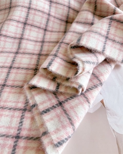 Close-up of pink and grey checkered pashmina fabric with soft cashmere texture