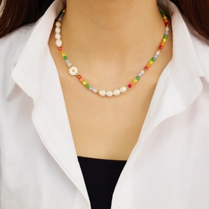 Bohemian colorful beaded necklace with pearls and daisy pendant on female model