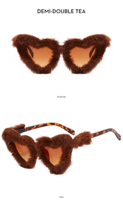 Detail of plush heart-shaped sunglasses with brown gradient lenses and faux fur texture
