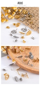 Detail view of gold and silver textured teardrop earrings on a wooden display tray