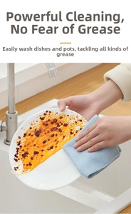Detail showing absorbent microfiber cleaning cloth removing heavy oil from a plate