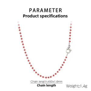 Close-up of red beaded stainless steel chain with dolphin-shaped lobster clasp detail