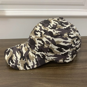 Tactical camouflage baseball cap for outdoor activities on a wooden surface