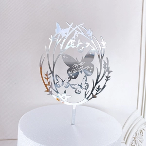 Detail of silver mirror acrylic cake topper with butterfly wreath and Happy Birthday text