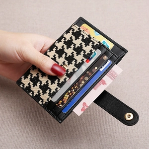 Slim houndstooth card holder for women with black leather trim and gold snap closure