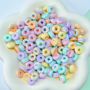 Macro view of colorful resin donut charms for DIY nail art and jewelry making