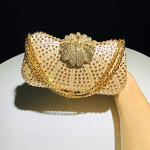 Detail of champagne gold evening bag with rhinestones and floral metal clasp