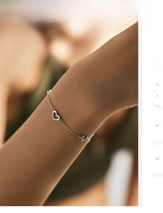 Close-up of S925 sterling silver bracelet with hollow heart and crystal letter charms
