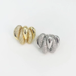 Irregular twisted C-shaped rings with sparkling diamonds in gold and silver finish