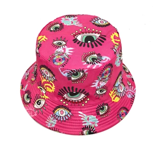 Hot pink bucket hat featuring vibrant pop-art eye patterns and graffiti canvas style