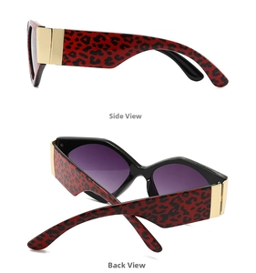 Detail of red tortoiseshell sunglasses with gold metal accents and gradient lenses