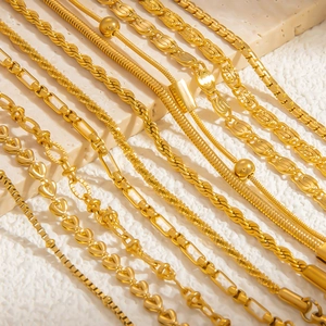 Detail showing various 18k gold plated stainless steel chain styles on marble base