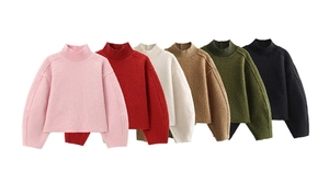 Close-up of soft textured knit sweaters in pink, red, beige, camel, green, and black colors