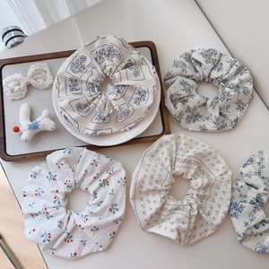 Detailed set of five Korean style floral cotton scrunchies in assorted pastel patterns