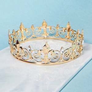 Detailed view of luxury gold bridal crown with crystal rhinestones on marble surface