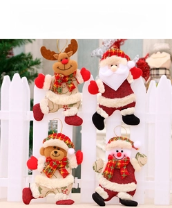 Close-up of four Christmas plush ornaments featuring Santa, reindeer, bear and snowman