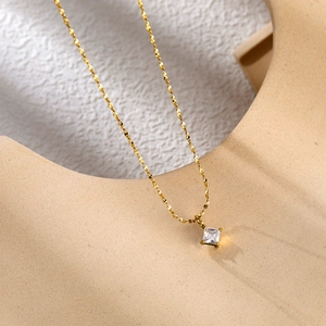 Elegant 18K gold plated titanium necklace with square zircon pendant on a minimalist stand