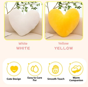 Detail showing plush heart-shaped pillows in white and yellow with soft furry texture