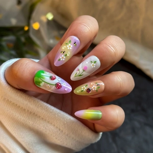 Almond-shaped press-on nails with 3D strawberry, cute ladybug, and floral nail art designs