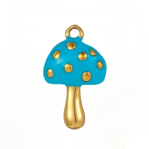 Golden mushroom pendant with turquoise enamel inlay and small loop on white background