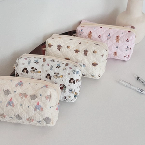 Detailed view of four quilted pencil cases with various cute animal prints and zipper closure