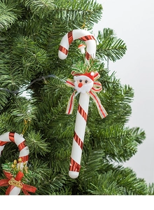 Detail of Christmas candy cane hanging ornament with bow and Merry Christmas tag on tree