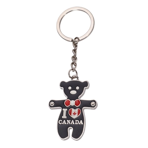 Black metal teddy bear keychain with Canada flag heart and red bowtie on white background