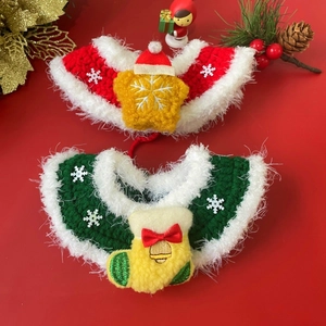 Detail of red and green hand-knitted Christmas pet collars with festive ornaments
