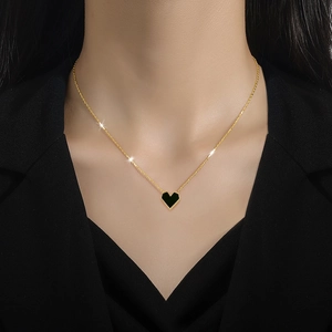 Minimalist titanium steel gold necklace featuring a black heart-shaped mother-of-pearl pendant