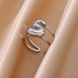 Detail view of silver adjustable ring featuring a polished double-layered letter S design