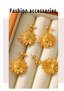 Detailed macro view of four golden sunflower titanium earrings in a beige jewelry box