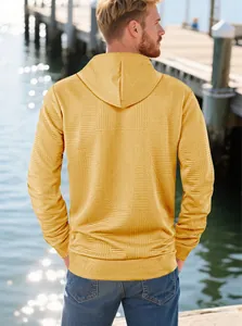 Outdoor back view of men's ginger hoodie with geometric jacquard texture and ribbed hem