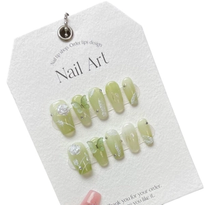Handmade light green gradient press-on nails with 3D white flowers and butterfly charms