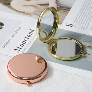 Portable round folding metal makeup mirrors in polished gold and rose gold finishes