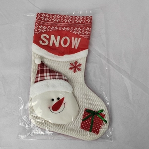 White knit Christmas stocking with snowman decor and SNOW text for holiday decor