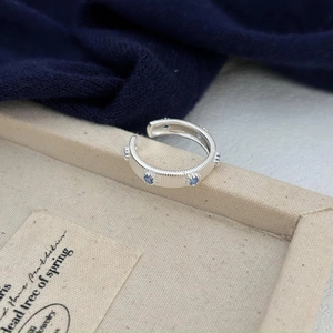 Elegant S925 sterling silver open ring featuring blue zircon stones on textured display