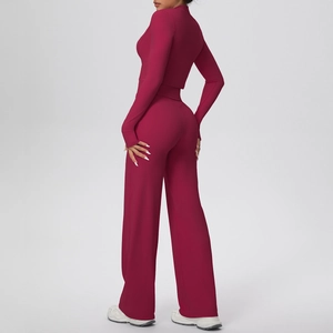 Rear side view of burgundy long sleeve crop top and high-waist wide leg yoga pants