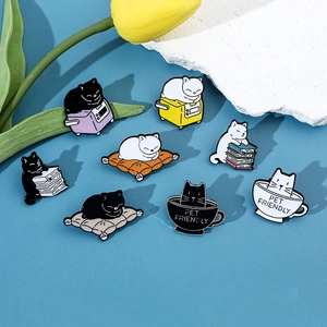 Detail of eight cute cartoon cat enamel pins featuring cats reading books and in cups