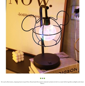 Detail of Mickey silhouette desk lamp with black metal finish and colorful bulb