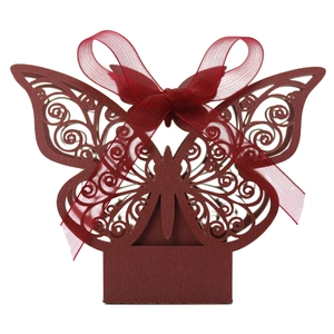 Detail of laser-cut burgundy butterfly favor box with elegant swirls and ribbon bow